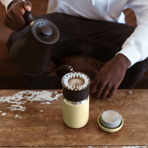 Person using Fellow Stagg EKG Electric kettle to make a coffee pourover.