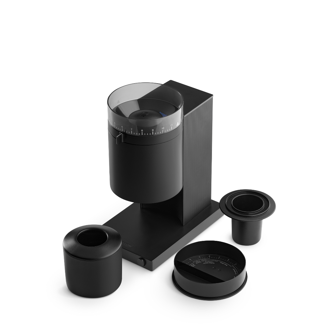 The Fellow Opus coffee grinder with a black finish with additional pieces.