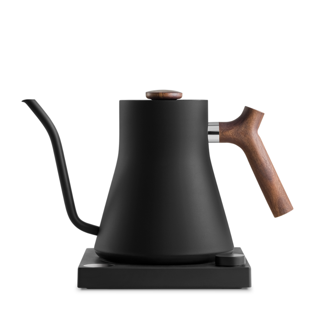 Fellow Stagg EKG Electric Kettle with matte black finish and walnut accents on base.