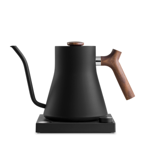 Fellow Stagg EKG Electric Kettle with matte black finish and walnut accents on base.