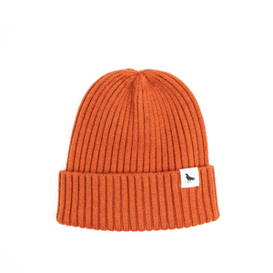 Orange wool beanie with a tag depicting a crow.